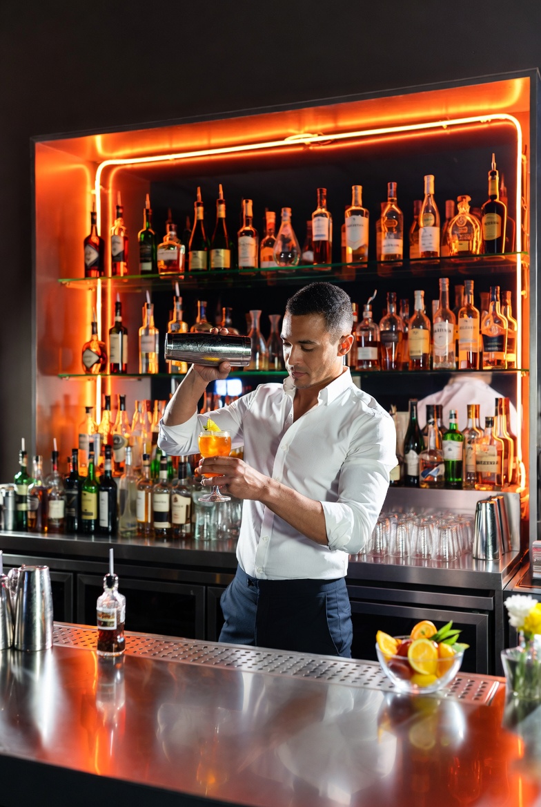 Professional bartender mixing cocktails for mobile bartending insurance page