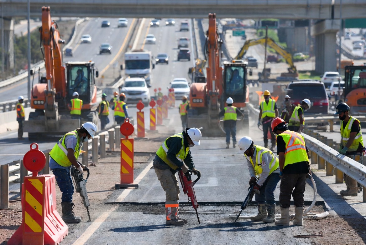 Roadway workers on a highway maintenance project — KIG insures TMA truck operators, traffic control crews, and high-hazard construction contractors