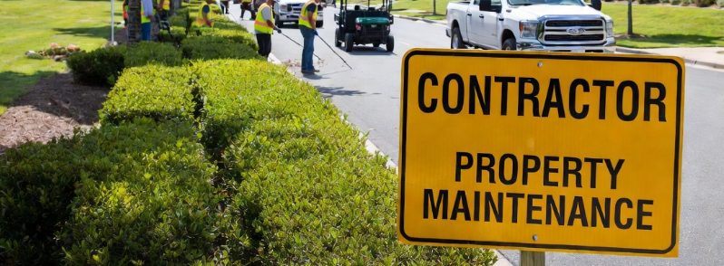 Commercial tree contractor crew with yellow signage performing tree maintenance at a corporate campus - Kelly Insurance Group