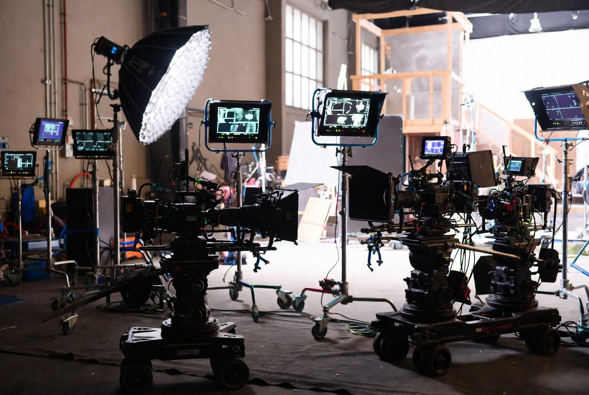 Entertainment production company film set with cameras, lighting rigs, crew, and production insurance exposures