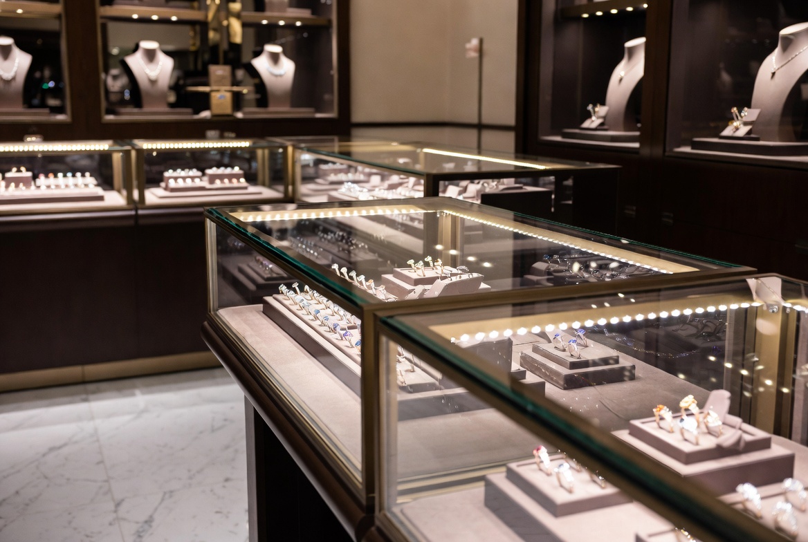Elegant fine jewelry retail showroom with luxury display cases and sparkling inventory