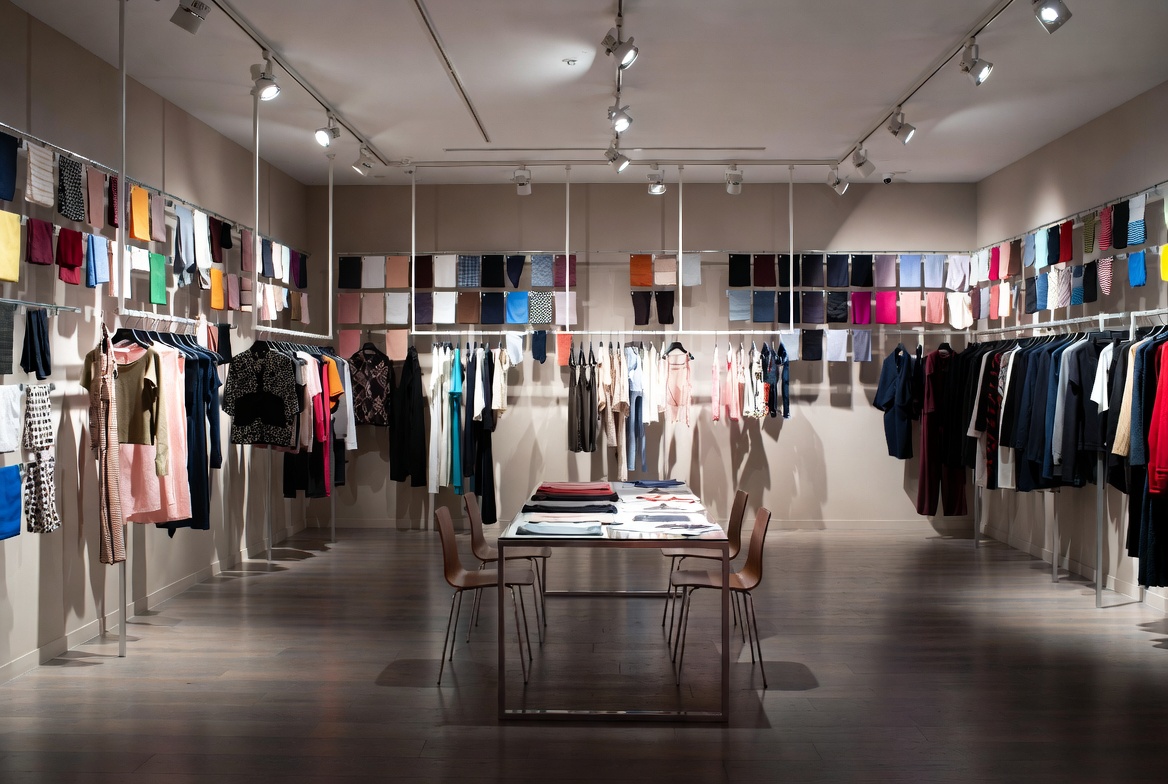 Fashion showroom sample room with fabric mood boards, private viewing space, and curated collection presentation for wholesale buyers