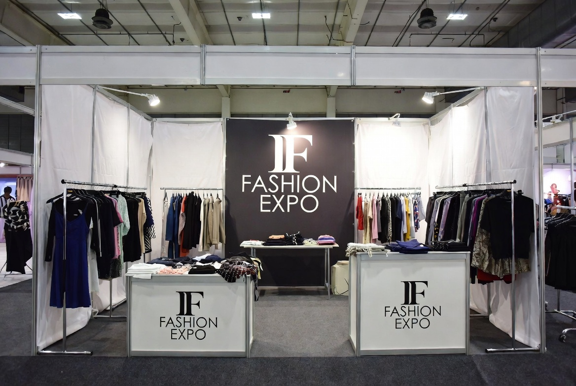 Fashion trade show vendor booth setup with racks and promotional displays at exhibition hall for trade show vendor insurance