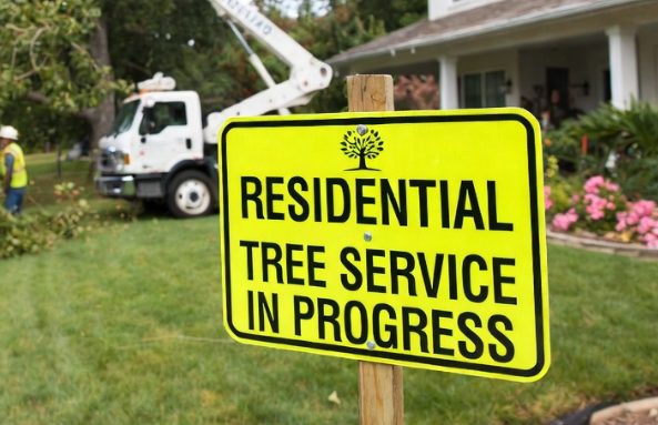 Residential tree service insurance yellow residential tree service sign with bucket truck and home