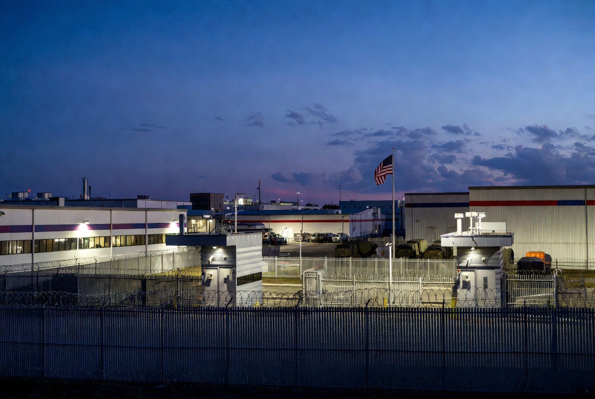 Secure defense contractor facility with high security fencing and military base access controls