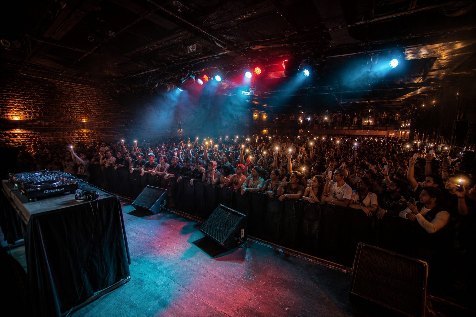 DJ and crowd at a hip hop club show, the venue-operator setting that calls for the room's own ongoing insurance program
