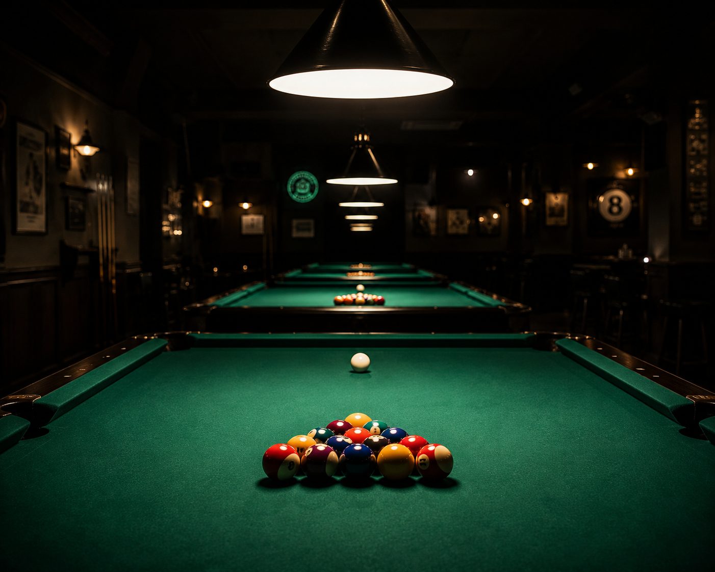 Pool hall with green felt tables under overhead lamps for pool hall insurance